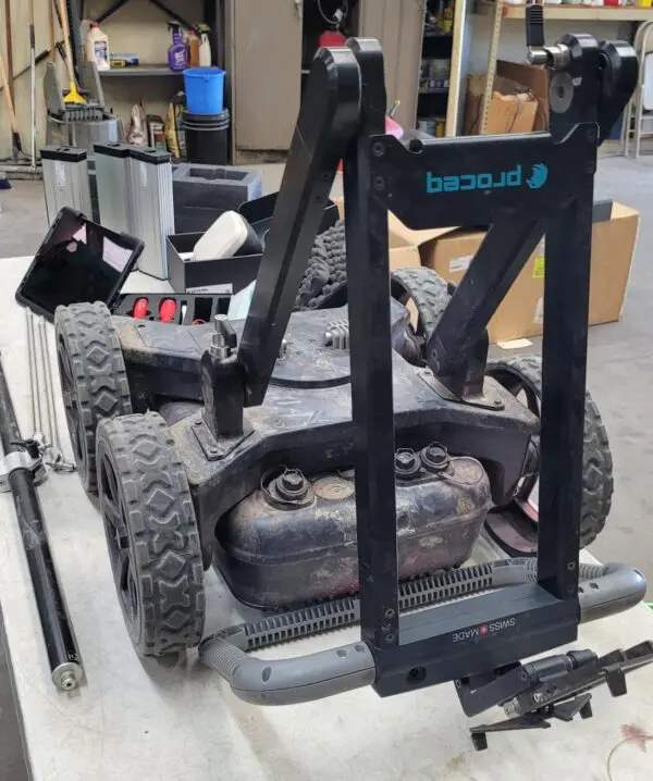 A Screening Eagle Proceq GS800 Subsurface Mapping System is sitting on top of a table in a garage.